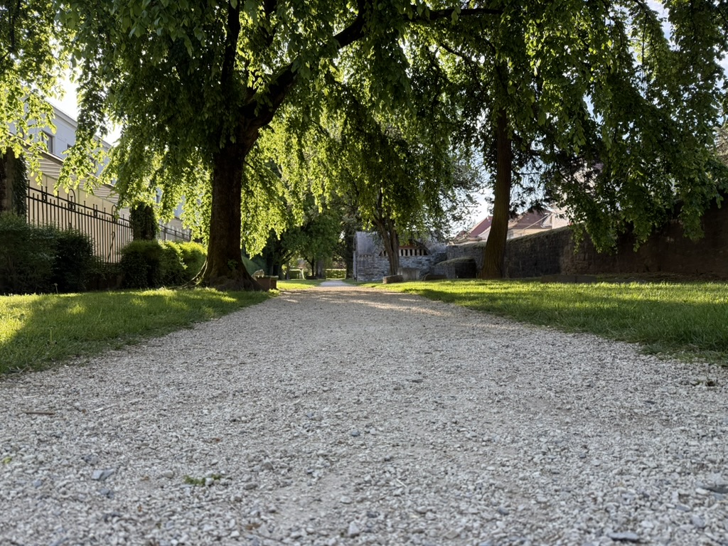 Spring morning light on a gravel path beside the Roman wall on Mirje in Ljubljana